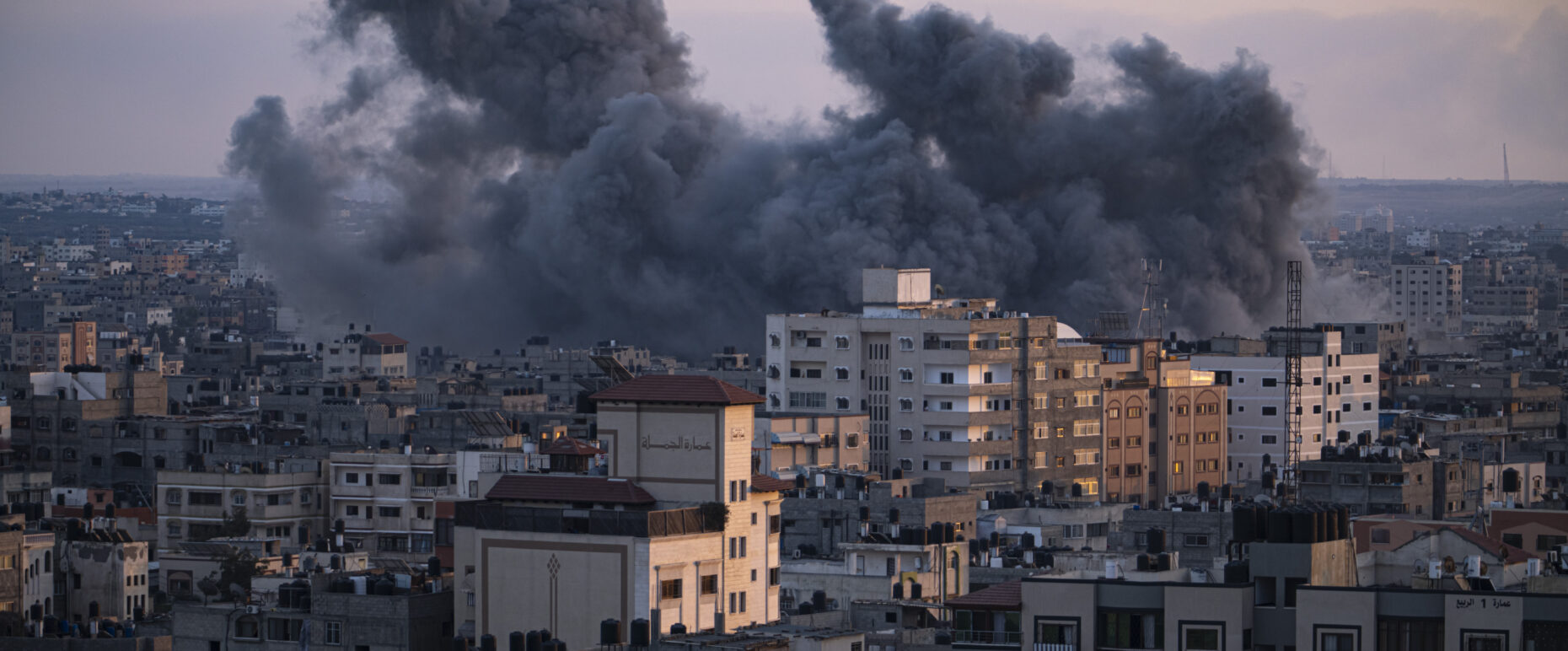Black smoke rising above buildings following Israeli airstrike in gaza city